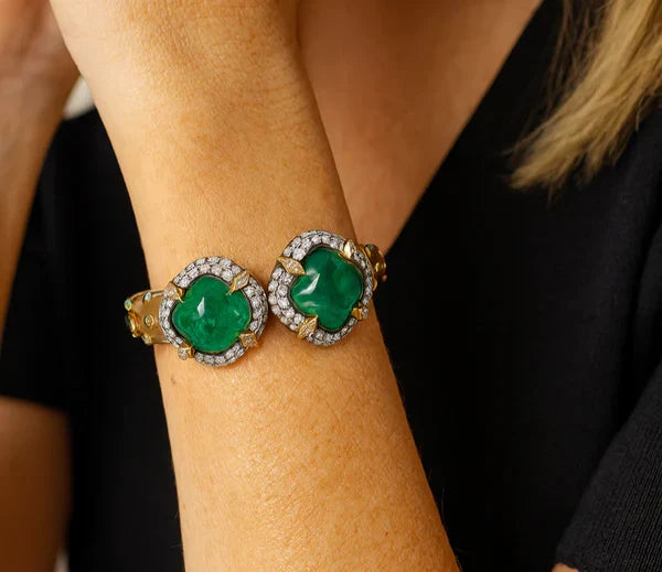 Two cabochon emerald and diamond cluster bracelets worn on the wrist, G Marie Luxuries Virginia Beach emerald jewelry collection